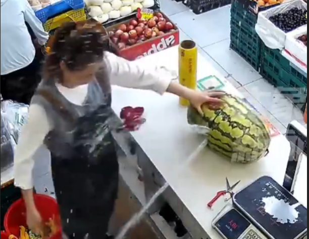 一名店员切开一块西瓜时，瞬间有两股水柱喷涌而出-春天资源分享网